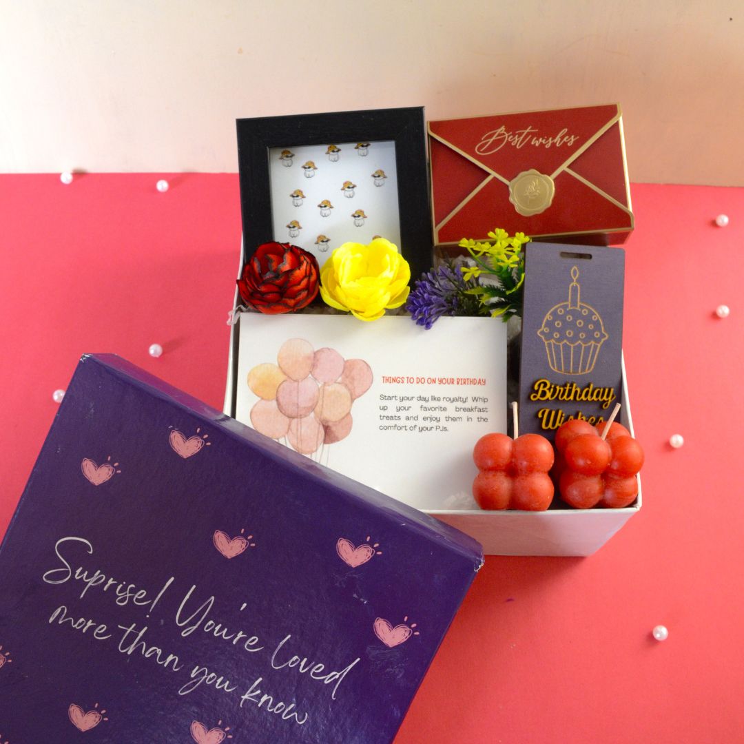 Birthday Essential Hamper : This Hamper Contains: Mini photo frame with print, ⁠Pinata chocolates in best wishes box, ⁠Pair of mini bubble scented candle, Set of “Things to do on your birthday” cards, ⁠Birthday wishes tag, Flower bunch and Surprise heart box