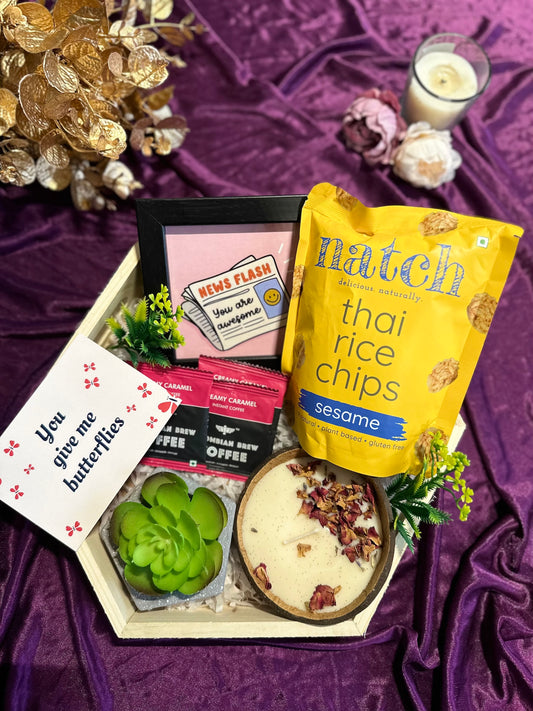 Cheerful_Indulgence_Tray_Hamper Contains:
Hexagonal Pinewood Tray,
Coconut Shell Candle,
You're Awesome Photo Frame,
Thai Rice Chips,
Artificial Succulent Hexagonal,
3 Premium Coffee Sachets,
"You give me Butterfly" Gift Card
