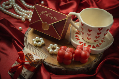 Love in Bloom Hamper Contains: Heart Cup & Saucer set, Almond Brittle (set of 2), Best Wishes Chocolate Box, Pinata Shape Chocolates (5pieces), Mini Scented Bubble Candle (set of 2), Pinewood Crate Basket and Ribbon Bow with a pearl